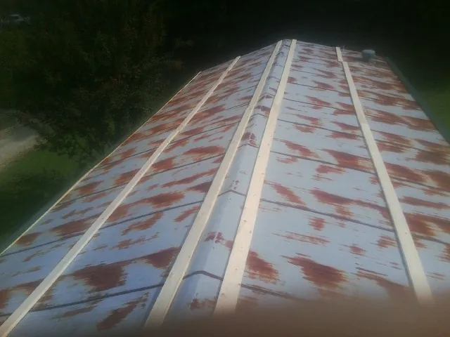Rusted metal roof panels with new wood purlins before replacement — Storm Damage Roof Repair in Duck River by Roofing Brothers